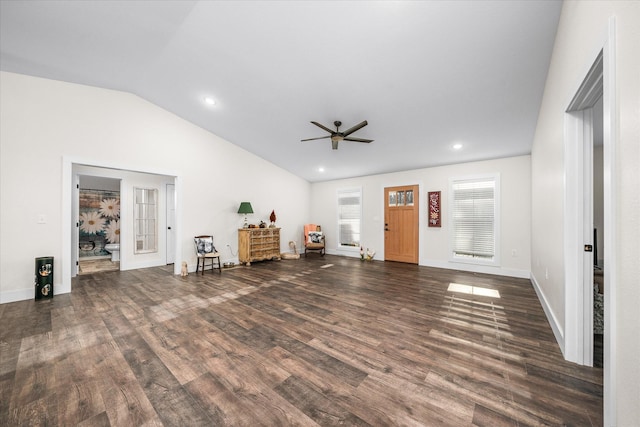 unfurnished living room featuring dark hardwood / wood-style floors, vaulted ceiling, and ceiling fan