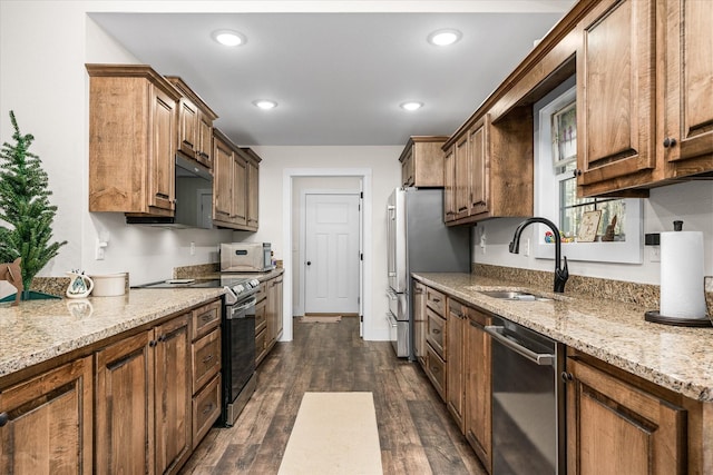 kitchen featuring dark hardwood / wood-style floors, sink, light stone countertops, and stainless steel appliances