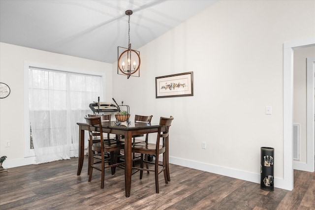 dining space featuring dark hardwood / wood-style floors and an inviting chandelier