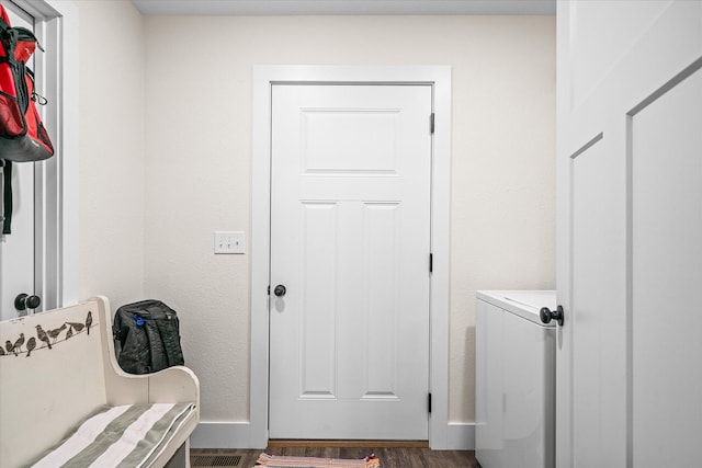 interior space featuring dark wood-type flooring and washing machine and clothes dryer