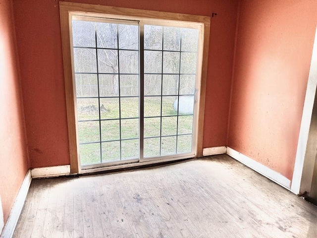 unfurnished room with hardwood / wood-style flooring