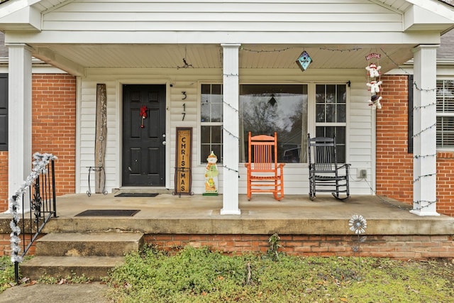 view of exterior entry with a porch