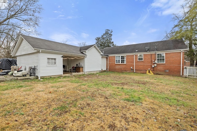 back of property with a patio area and a yard