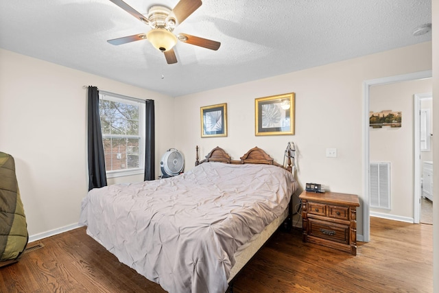 bedroom with ceiling fan, dark hardwood / wood-style flooring, and a textured ceiling