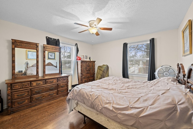 bedroom featuring hardwood / wood-style flooring, ceiling fan, a textured ceiling, and multiple windows