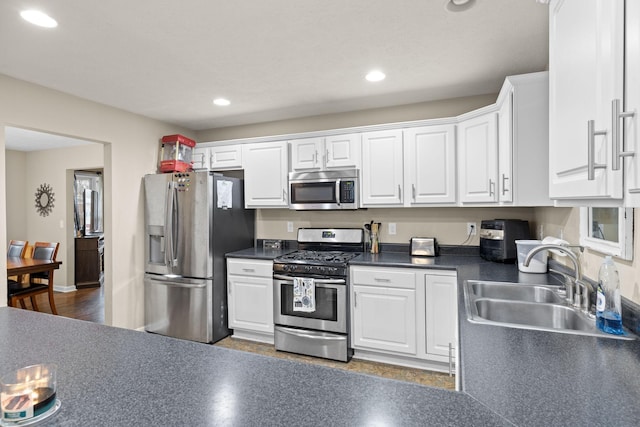 kitchen featuring sink, white cabinetry, and stainless steel appliances