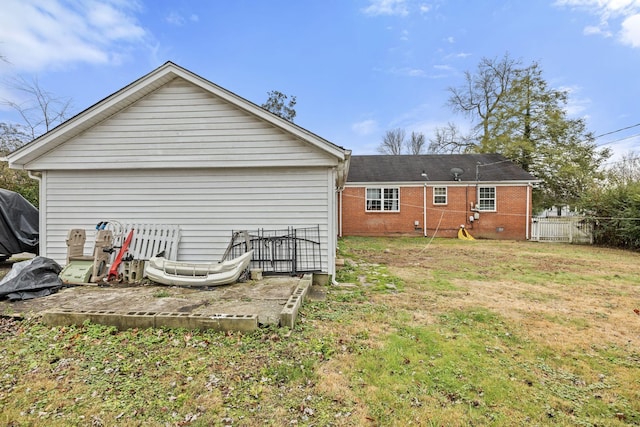 rear view of house featuring a lawn