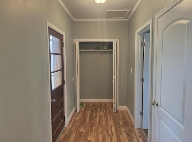 hallway with hardwood / wood-style floors and crown molding