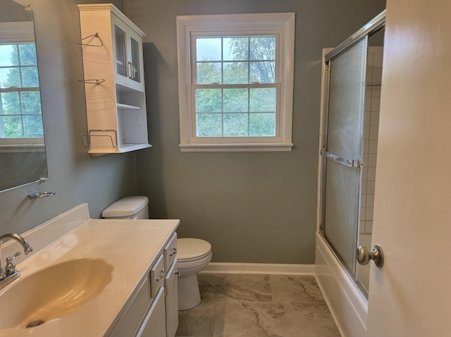 full bathroom with vanity, toilet, and bath / shower combo with glass door