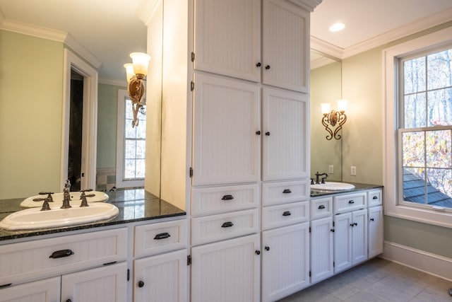 bathroom featuring tile patterned flooring, vanity, and crown molding