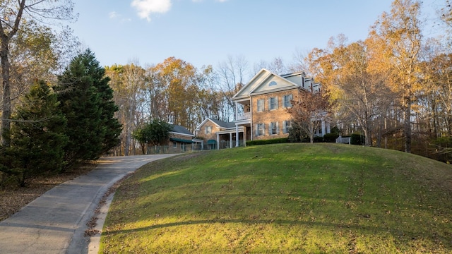 neoclassical home featuring a front yard