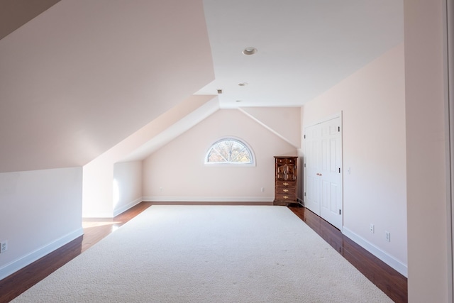 bonus room featuring dark hardwood / wood-style flooring and lofted ceiling