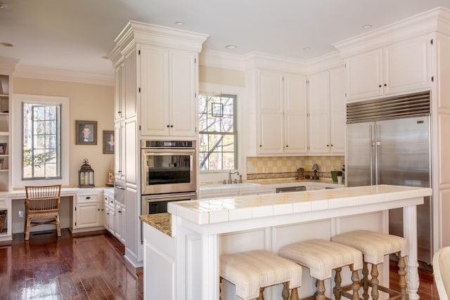 kitchen with tile countertops, white cabinetry, a wealth of natural light, and dark wood-type flooring