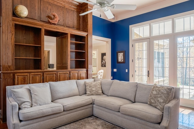 living room with ceiling fan, wood-type flooring, and crown molding