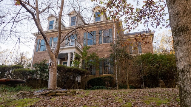 view of side of home featuring a balcony