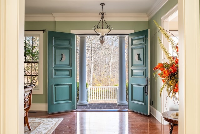 foyer featuring crown molding and dark hardwood / wood-style floors