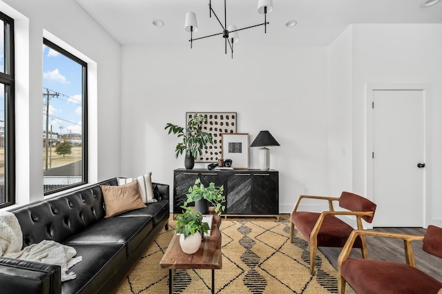 living room with hardwood / wood-style floors and a notable chandelier