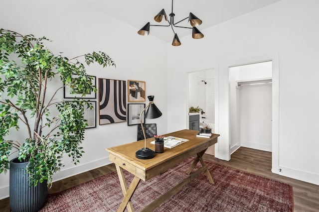 office area with dark hardwood / wood-style flooring, high vaulted ceiling, and an inviting chandelier