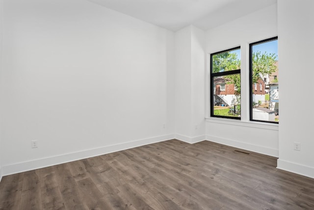 empty room with dark hardwood / wood-style floors