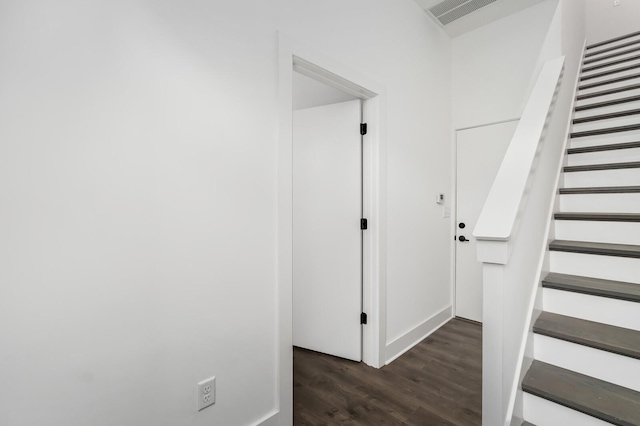 staircase with hardwood / wood-style floors