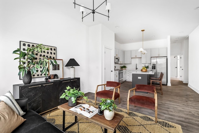 living room with a chandelier and dark hardwood / wood-style floors