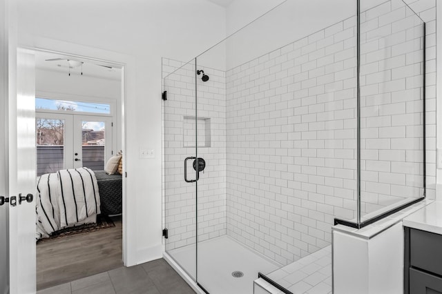 bathroom featuring tile patterned flooring, a shower with shower door, and french doors