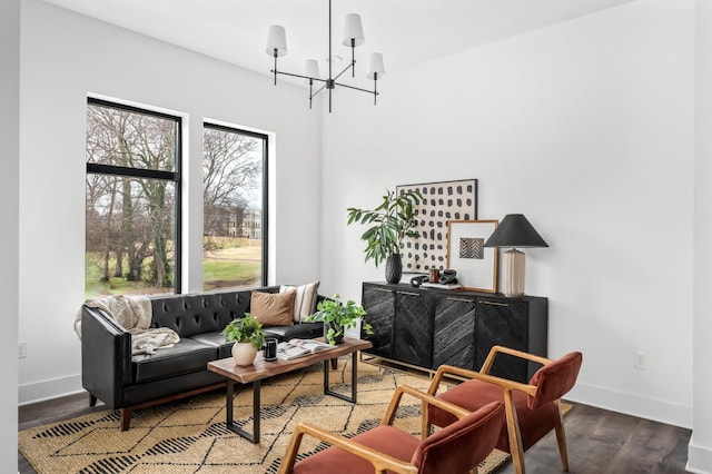 sitting room featuring hardwood / wood-style flooring and an inviting chandelier