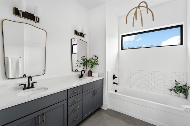 bathroom featuring tile patterned flooring, vanity, and a tub