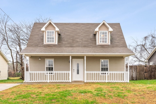 cape cod-style house featuring a front lawn and covered porch