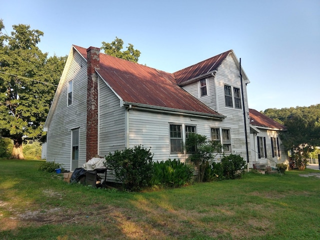 view of side of property with a lawn