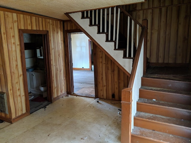 stairs with wood walls