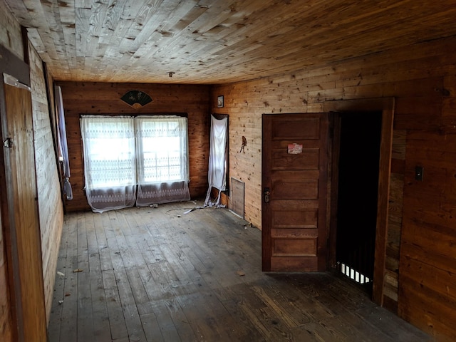 misc room featuring wood ceiling, wood walls, and dark wood-type flooring