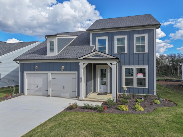 view of front of house with a front yard and a garage