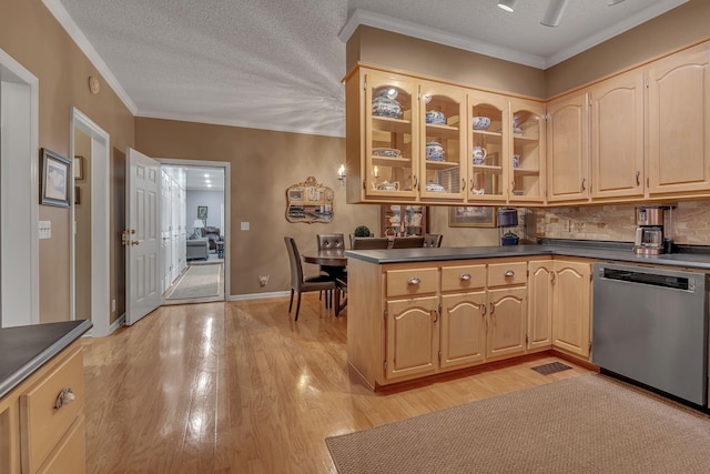 kitchen with backsplash, light hardwood / wood-style flooring, stainless steel dishwasher, and a textured ceiling