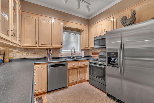 kitchen with light brown cabinetry, sink, stainless steel appliances, and a textured ceiling