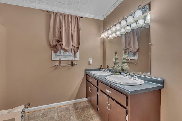 bathroom featuring vanity, crown molding, and a textured ceiling