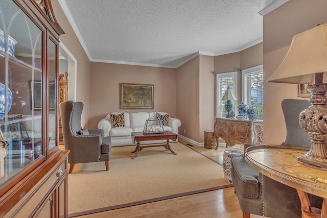 sitting room with a textured ceiling, light wood-type flooring, and ornamental molding