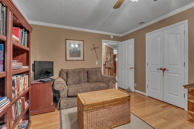 living room featuring a textured ceiling and light wood-type flooring