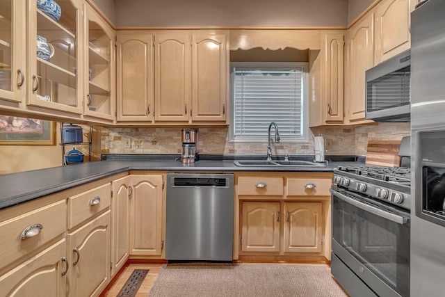 kitchen with decorative backsplash, sink, light brown cabinets, and appliances with stainless steel finishes