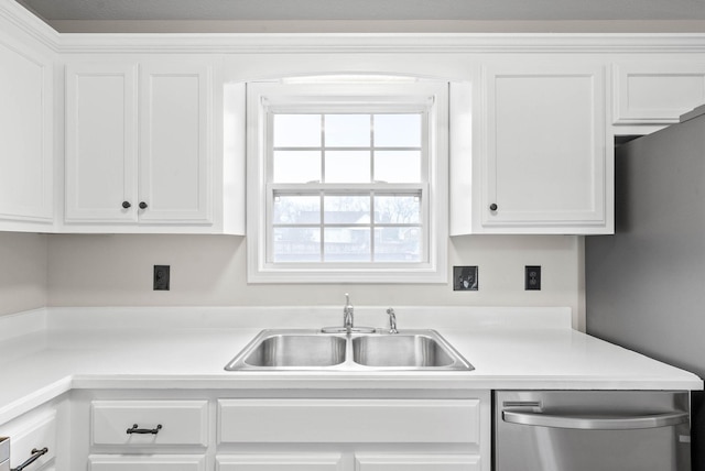 kitchen with white cabinets, dishwasher, and sink