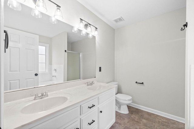 bathroom featuring vanity, toilet, and a shower with door