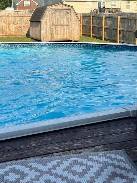 view of pool featuring a shed