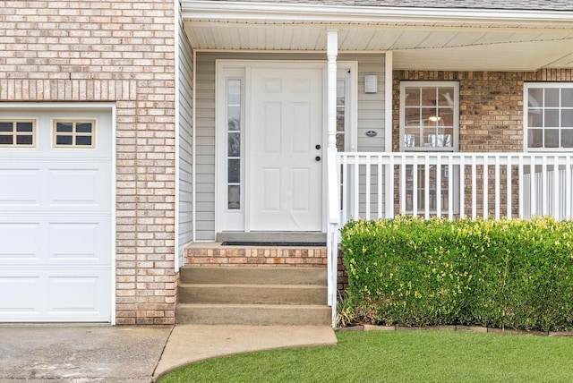 view of exterior entry with a garage