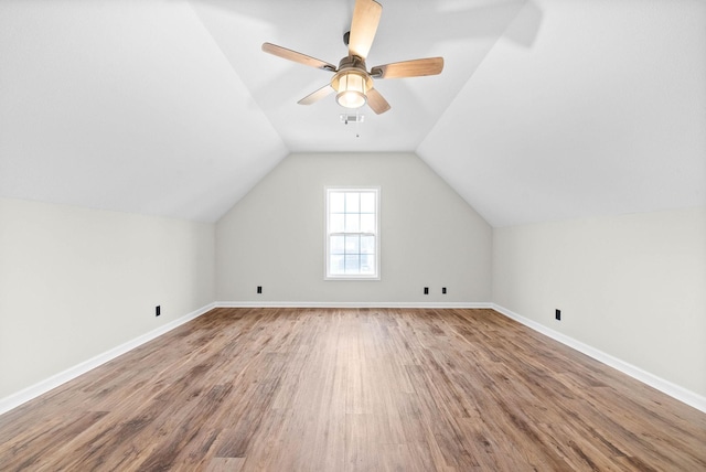 additional living space featuring ceiling fan, wood-type flooring, and vaulted ceiling