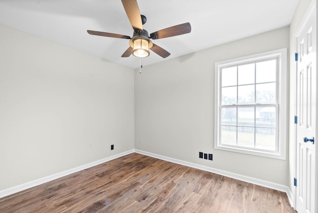 spare room featuring ceiling fan and light hardwood / wood-style flooring