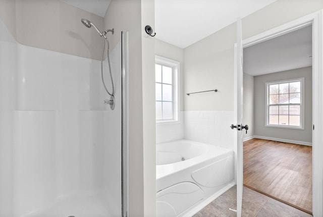 bathroom featuring wood-type flooring and independent shower and bath