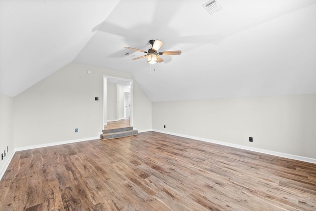 additional living space featuring light wood-type flooring, ceiling fan, and lofted ceiling