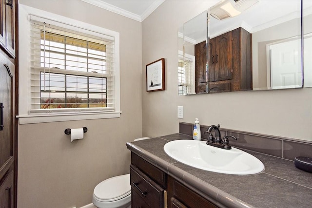 bathroom with vanity, toilet, and crown molding