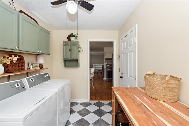 laundry area featuring ceiling fan, cabinets, washing machine and dryer, dark hardwood / wood-style flooring, and a textured ceiling