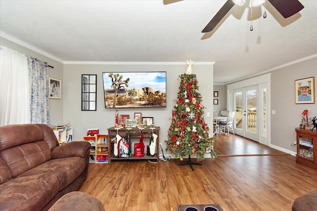 living room featuring hardwood / wood-style flooring, ornamental molding, and french doors